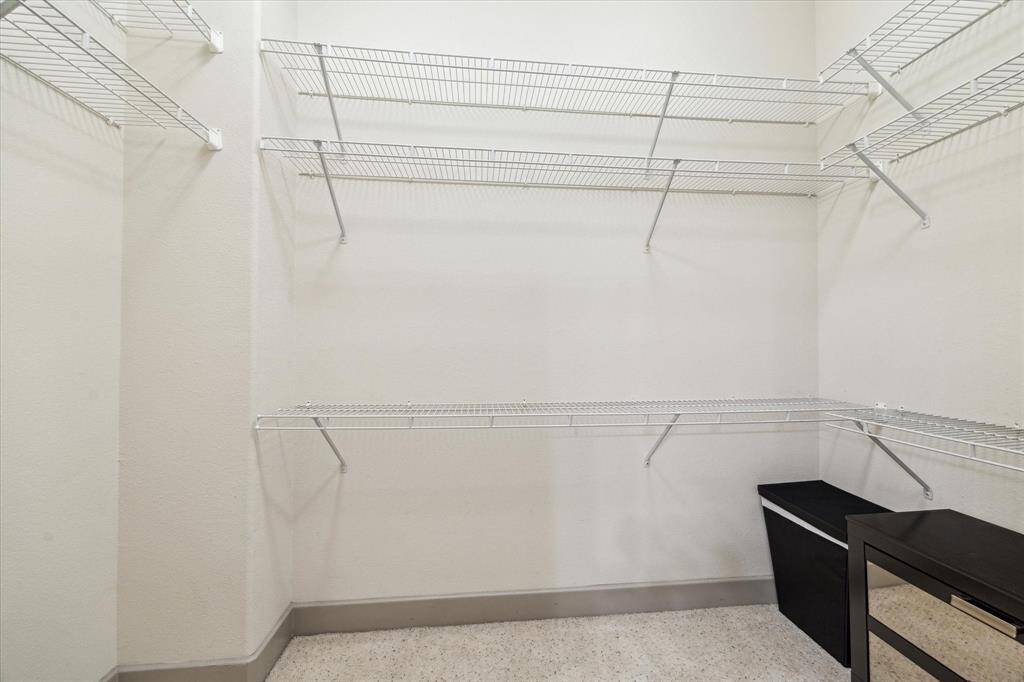 Generous closet space with built-in shelving and ample storage solutions.