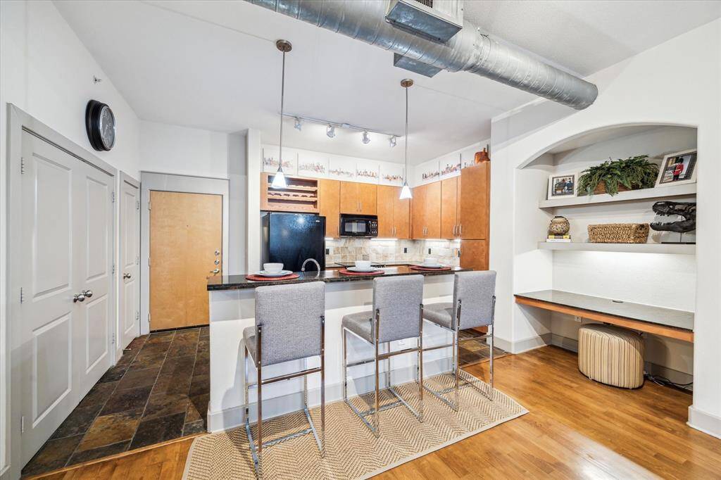Contemporary kitchen with adjacent desk area