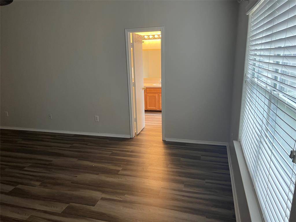 View of primary bedroom leading to ensuite bathroom.