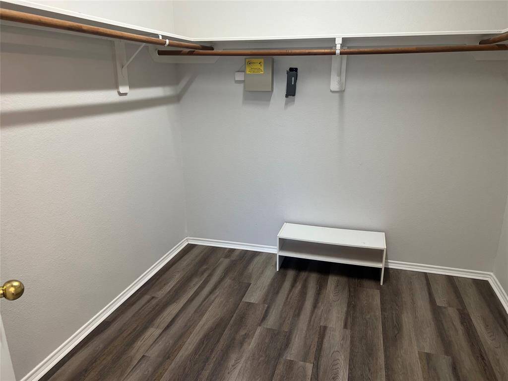 Huge walk-in closet offers plenty of space for storage and wardrobe.