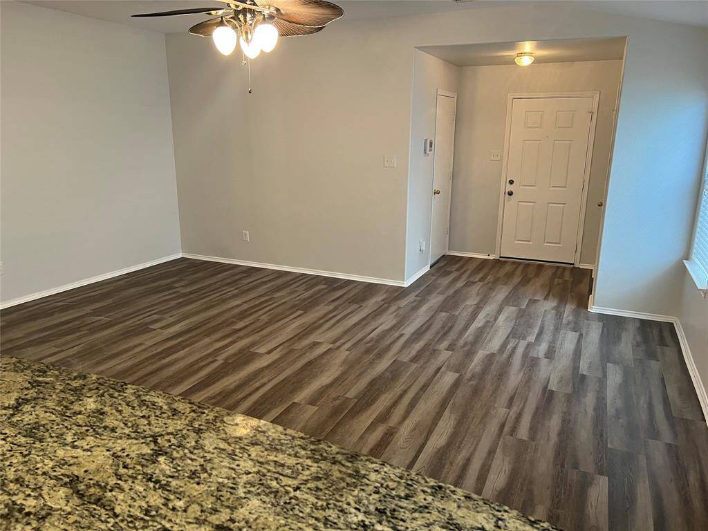 View of living room looking back toward the front door.