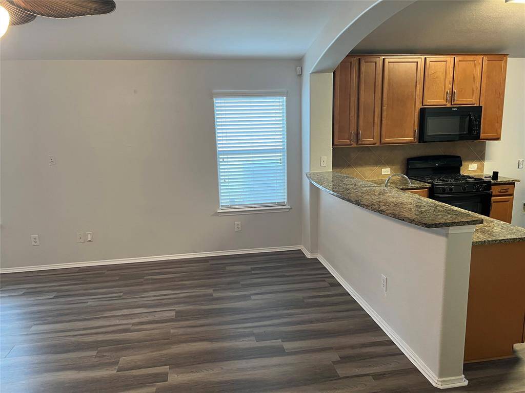 Kitchen has granite counters with. bar seating