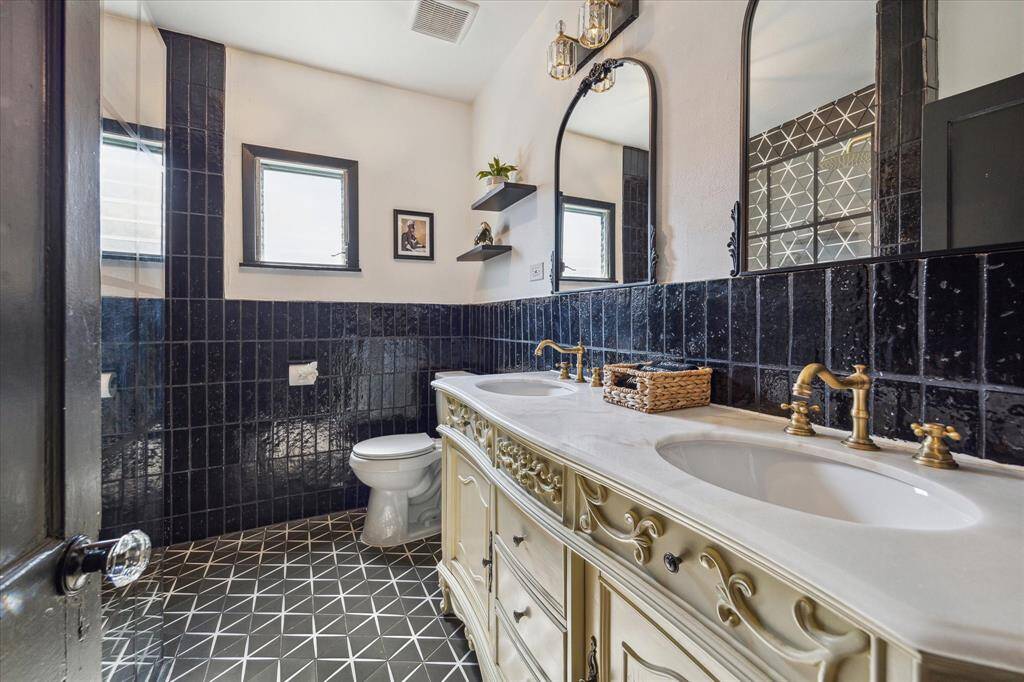 The ensuite bathroom has been completely updated with a double vanity and walk-in shower