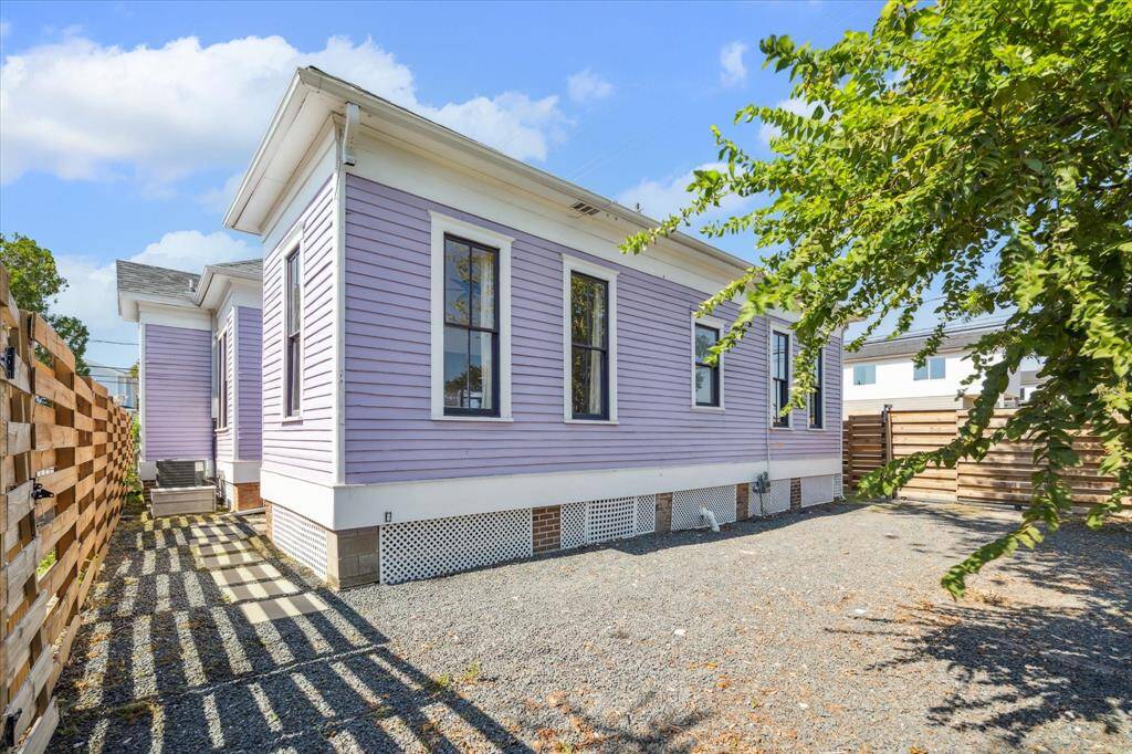 The backyard has been graveled for easy maintenance and can be used for parking inside the gate or as a traditional backyard space