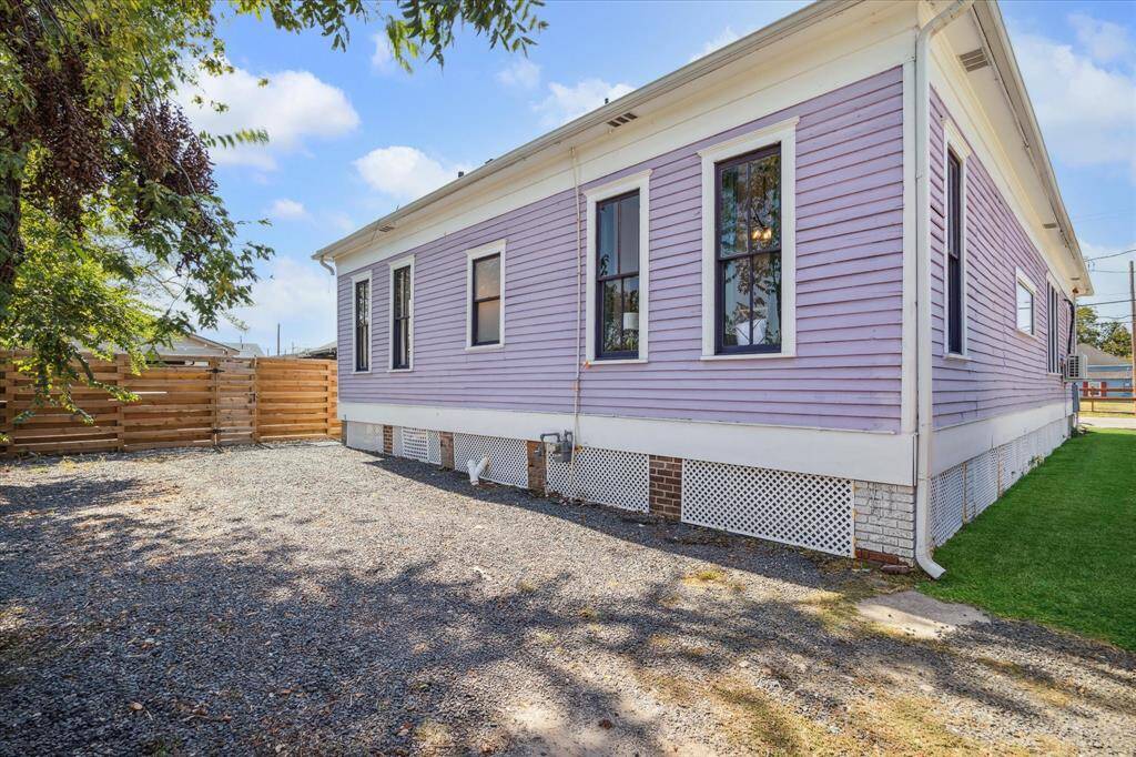 The fenced-in side yard connects the front and back yards
