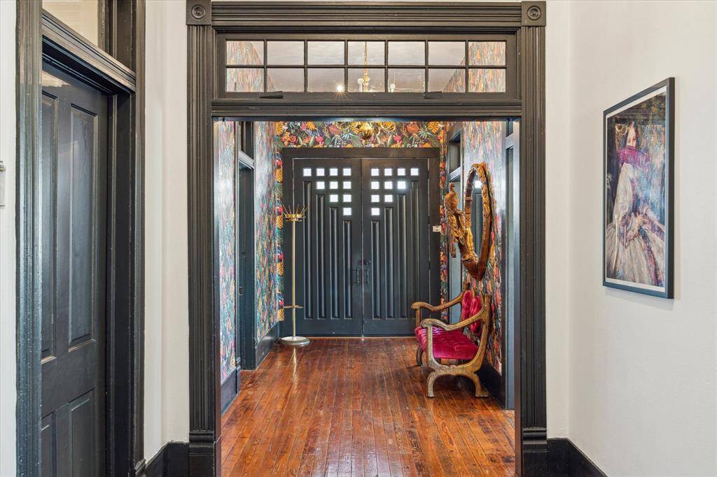 The original wood trim doorways were kept during the renovations; the foyer extends to the back entry of the house