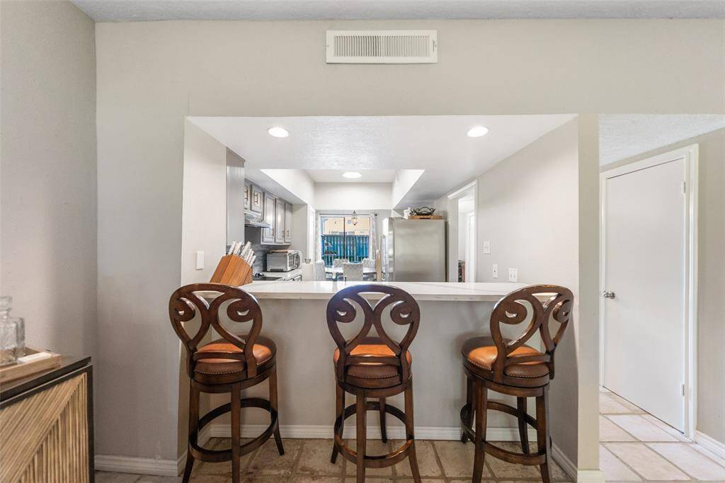 Pass through bar from kitchen to dining/living area with seating for 3 at the bar.