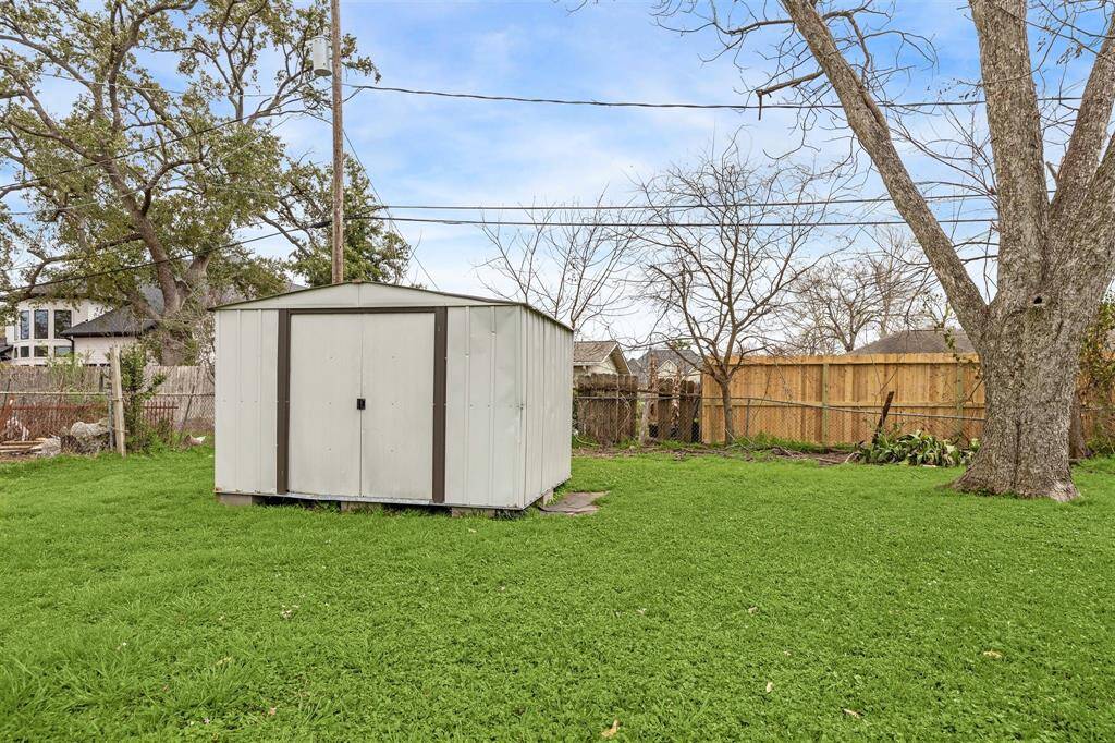 Convenient storage shed and fenced backyard