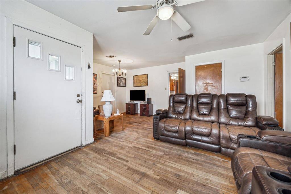 Spacious living area open to the extra room with a welcoming feel.