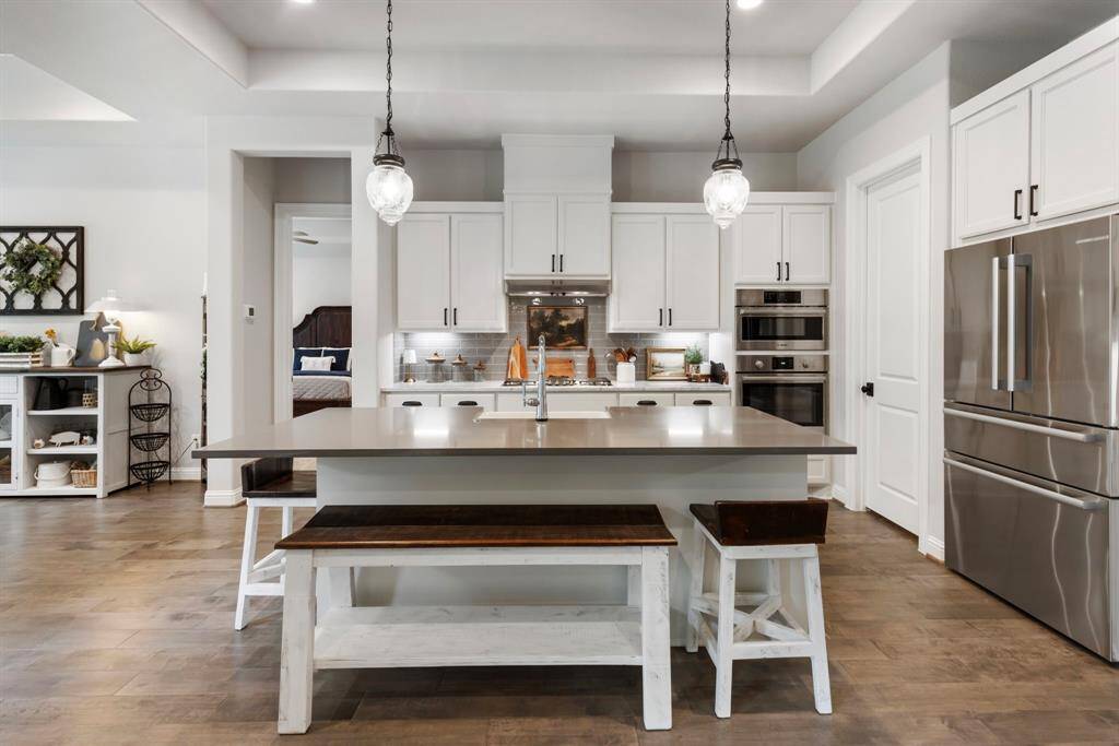 Island topped with quartz large enough for the whole family to feast around.