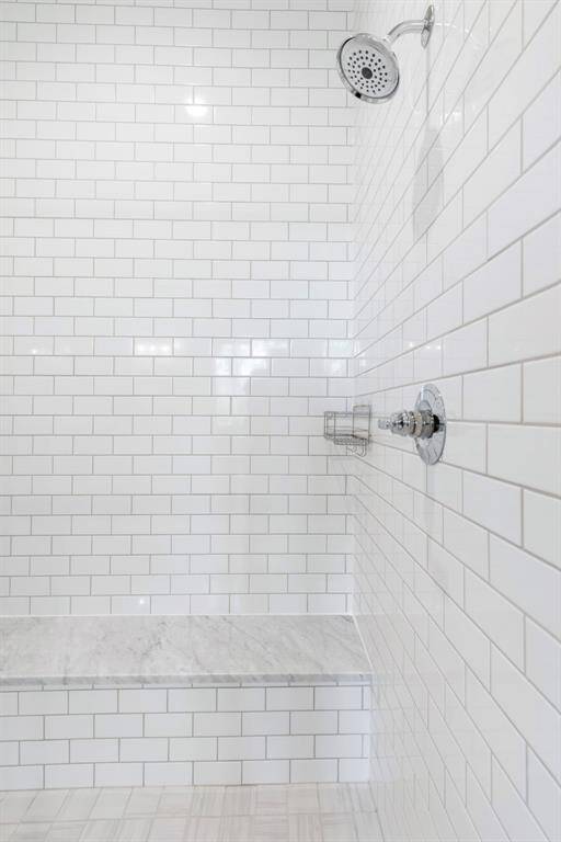 Words cannot describe the size of this shower.  Fully tiled on 3 walls with a glass front.  A carrara marble bench.  This shower is huge.