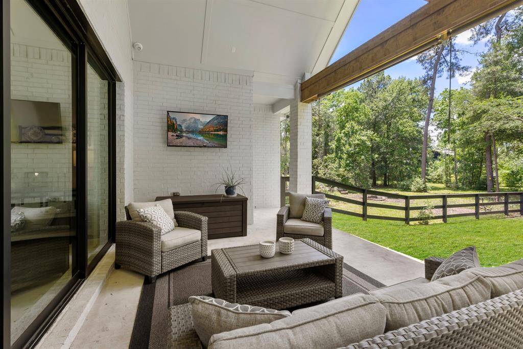 beyond the 16ft of sliding glass doors is the covered patio.  overlooking the 1 acre wooded property.