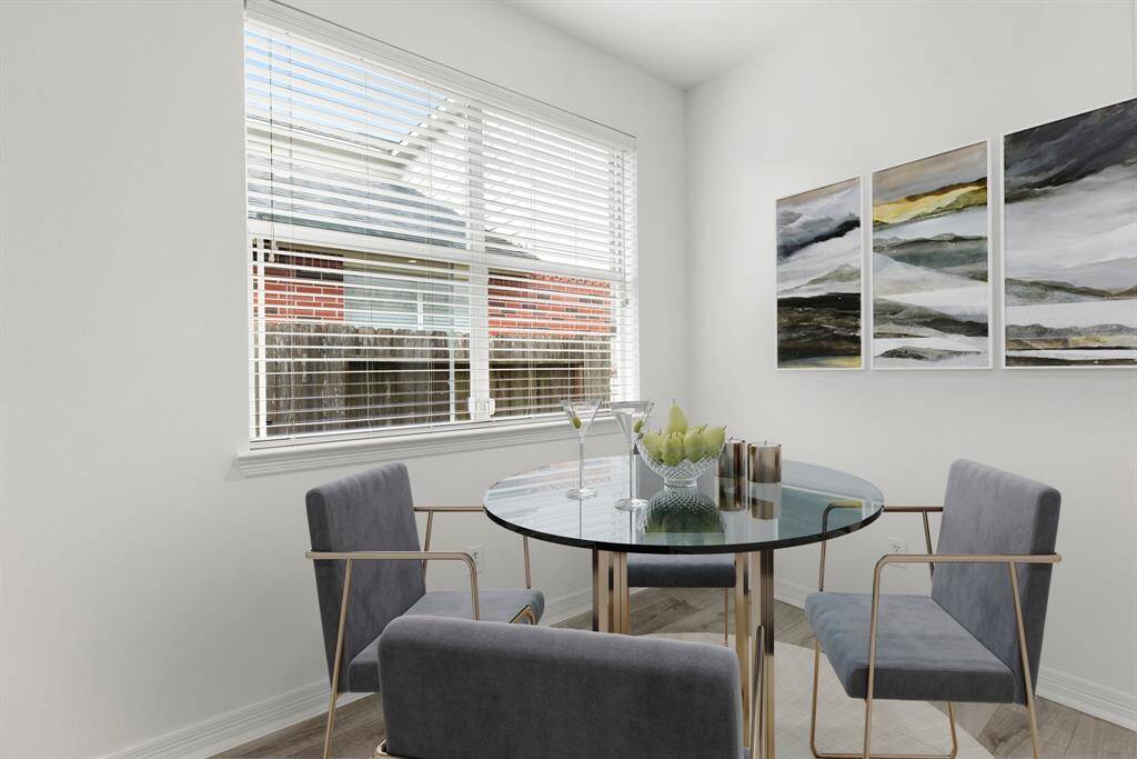 Start your day off right with a cup of coffee sitting with your family in the lovely breakfast area! Featuring large windows with blinds, fresh neutral paint, luxury vinyl plank flooring, and high ceilings.