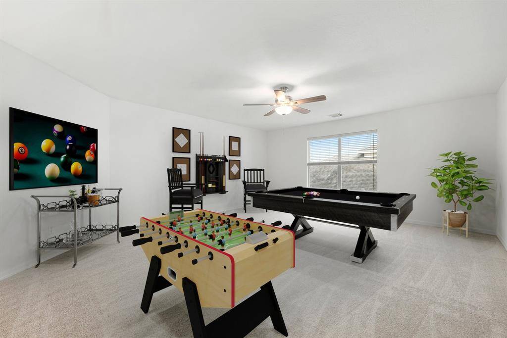 Perfect for entertaining is this amazing game room!  Right upstairs this space would be a fabulous teen hangout, media room, or adult game room complete with pool table and big screen TVs. Featuring plush carpet, high ceilings, dark stained ceiling fan, fresh paint and large windows with privacy blinds.