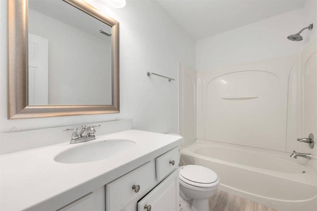 Secondary bathroom features Quartz countertops and bright cabinets, fresh paint, shower/tub combo, framed mirror, tile floors, sleek fixtures and modern finishes, plenty of space to accommodate any visiting family or guests.