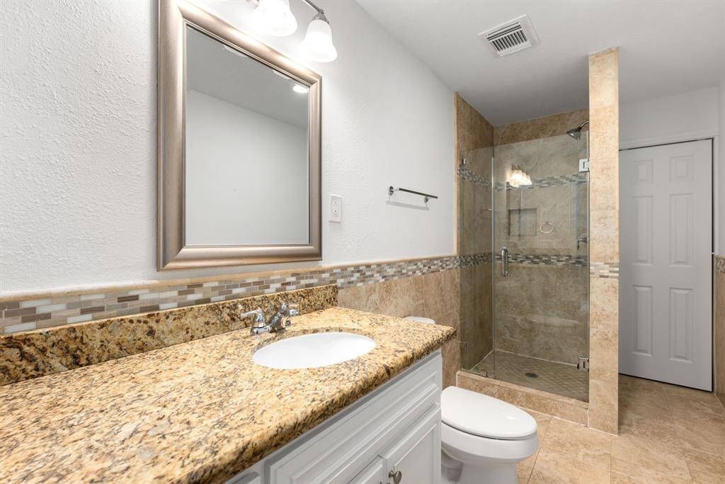 Secondary bathroom features Granite countertops and bright cabinets, fresh paint, oversized walk in shower, framed mirror, tile floors, sleek fixtures and modern finishes, plenty of space to accommodate any visiting family or guests.