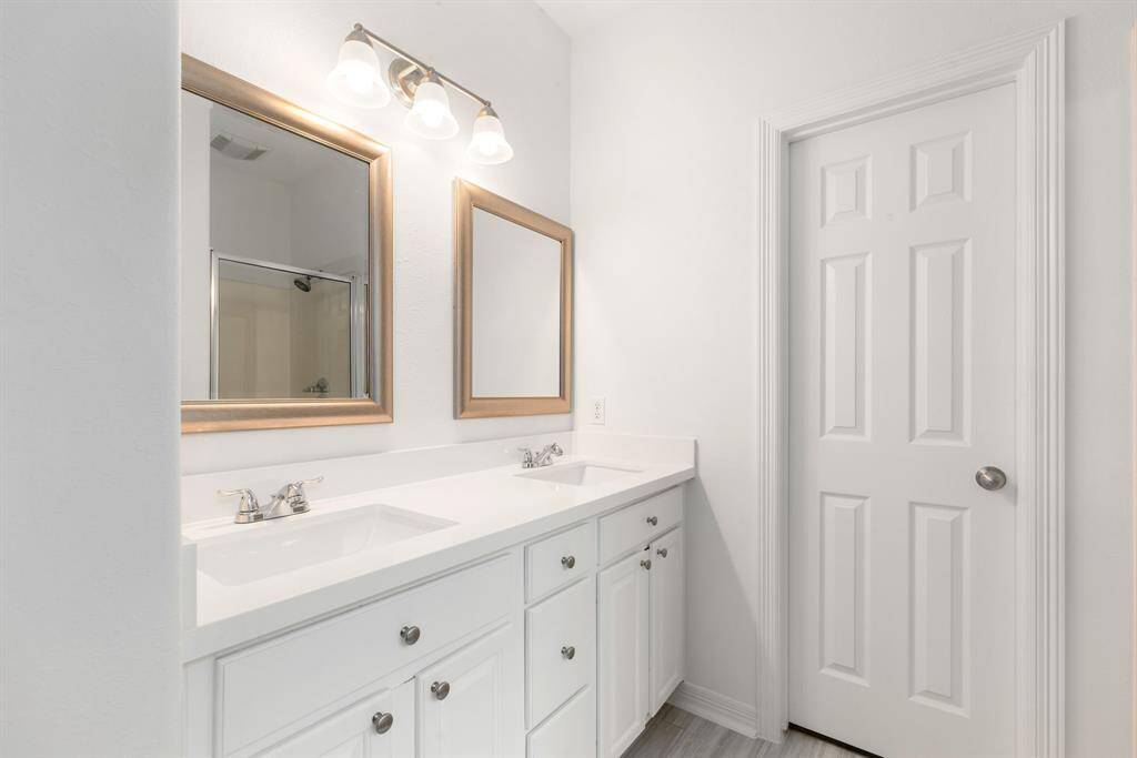 This primary bathroom is definitely move-in ready! Featuring a framed walk-in shower, separate garden tub for soaking after a long day, bright white cabinets with Quartz countertops, spacious walk-in closet with shelving, high ceilings, fresh paint, sleek and modern finishes.