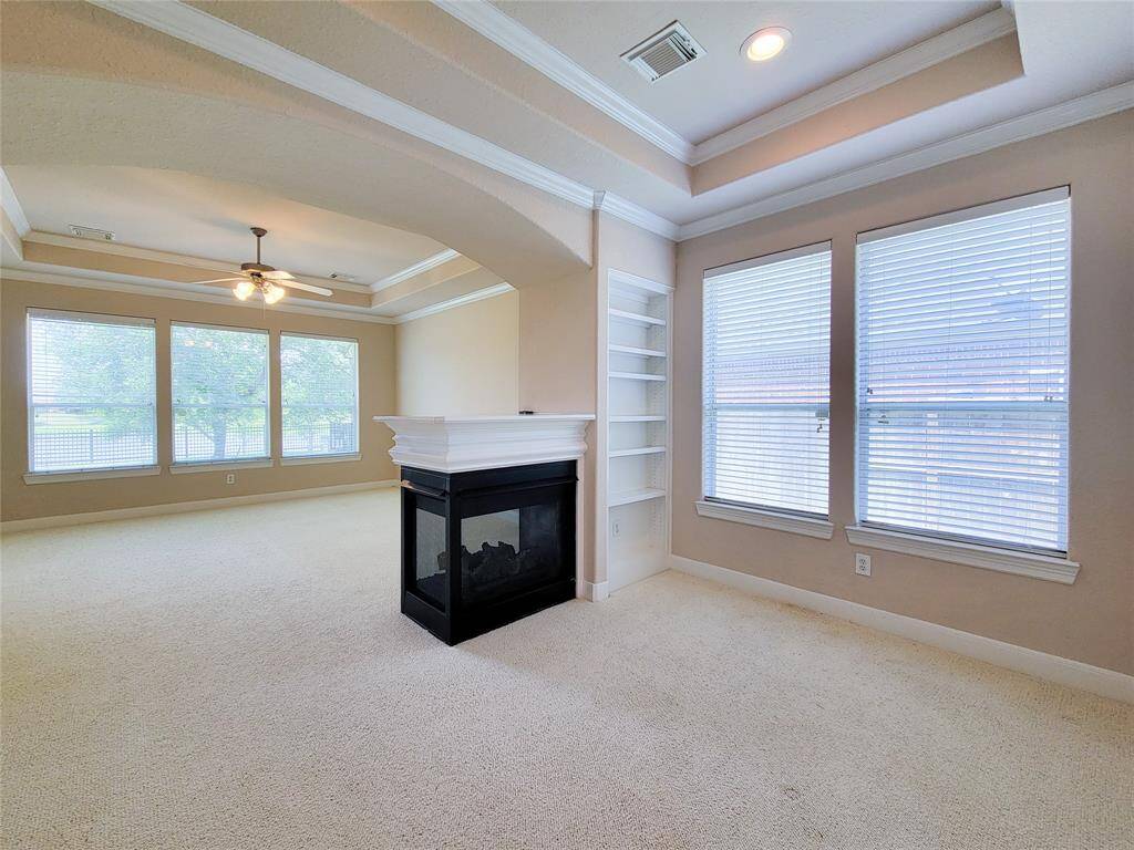 primary bedroom with three side fireplace and seating area/ nursery