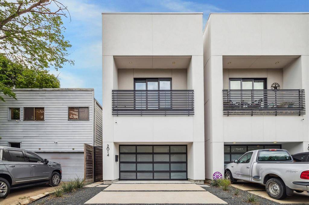 Bold and unapologetically modern—this sleek façade stuns with clean lines, a black metal balcony, and a frosted glass garage door that screams curb appeal. The stucco exterior was construction with rain screen technology, enhancing the durability and longevity of the facade.