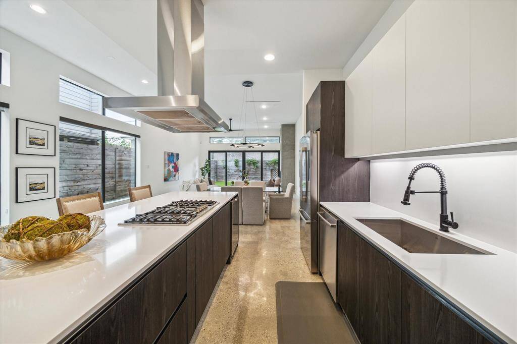 Sleek Italian cabinetry, quartz countertops, and under-cabinet lighting create a kitchen that’s as functional as it is stunning. A built-in beverage cooler adds a luxe touch, perfect for effortless entertaining.