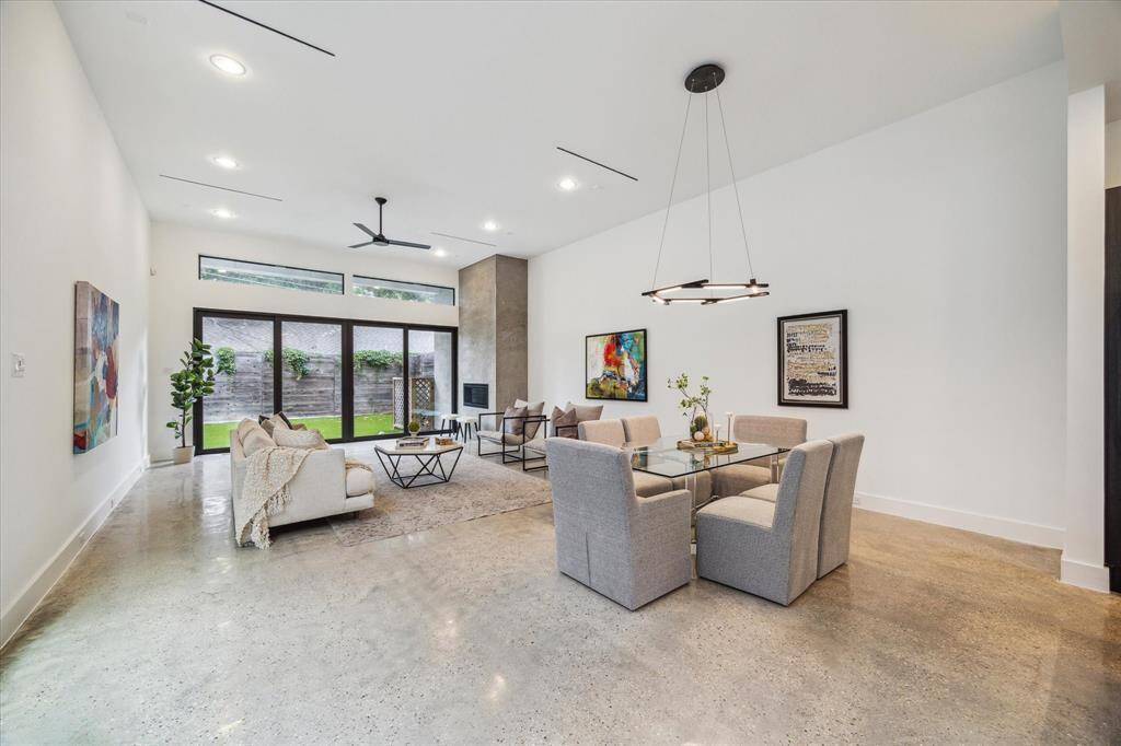 Effortlessly flowing from kitchen to living, the dining area offers the perfect setting for gatherings—intimate or grand. Oversized windows and tall ceilings amplify the space, while clean walls await your art collection.
