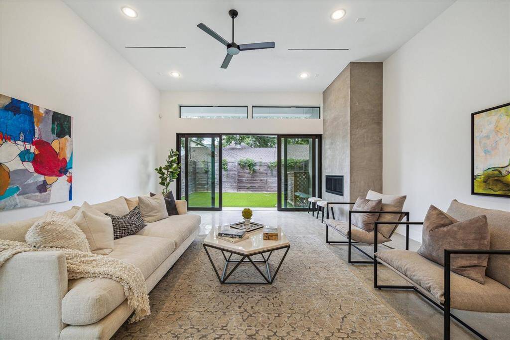 Soaked in natural light and grounded by polished concrete floors, this living space offers a seamless indoor-outdoor vibe with oversized sliders opening to your private backyard oasis.