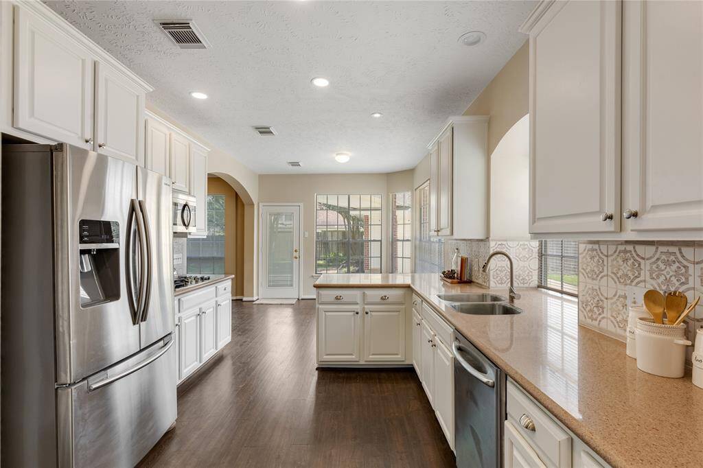 All of the appliances are stainless steel, and the refrigerator with two icemakers is included.