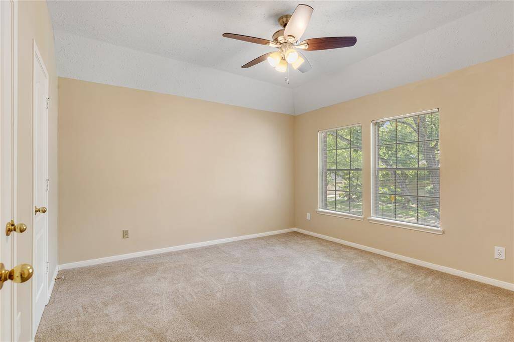 Bedroom #2 overlooks the front oak trees, has the new carpet and ceiling fan