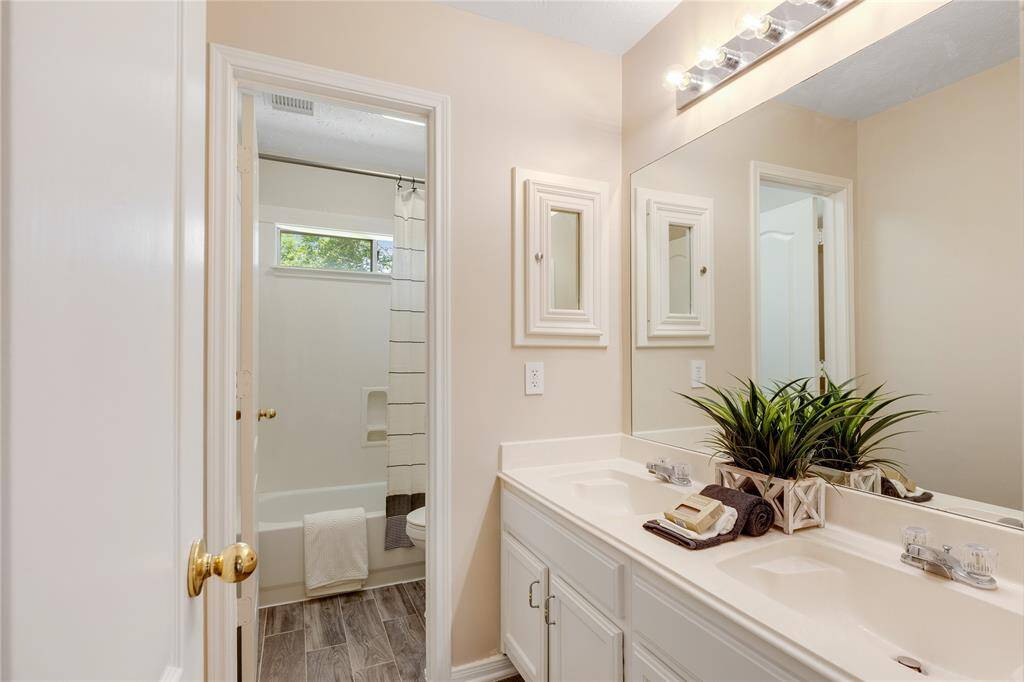 Full bath with double sinks and tub with shower