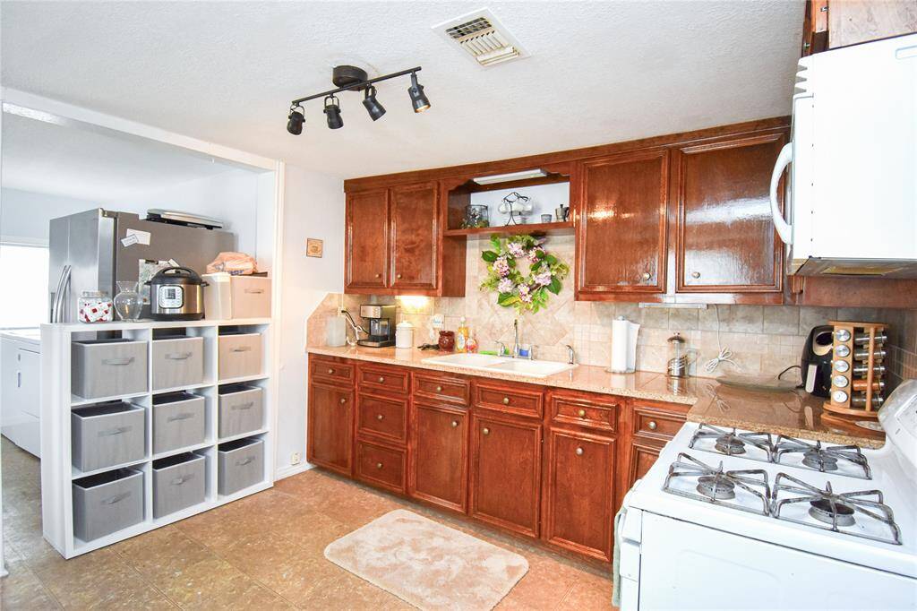 Enjoy ample cabinet, storage and countertop space in this open-concept kitchen- perfect for meal prep, hosting, and everyday living.