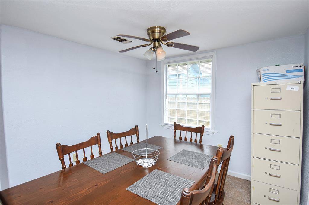 The dining area, seamlessly connected to the open kitchen, features a bright window that fills the space with natural light- perfect for casual meals or hosting guests.
