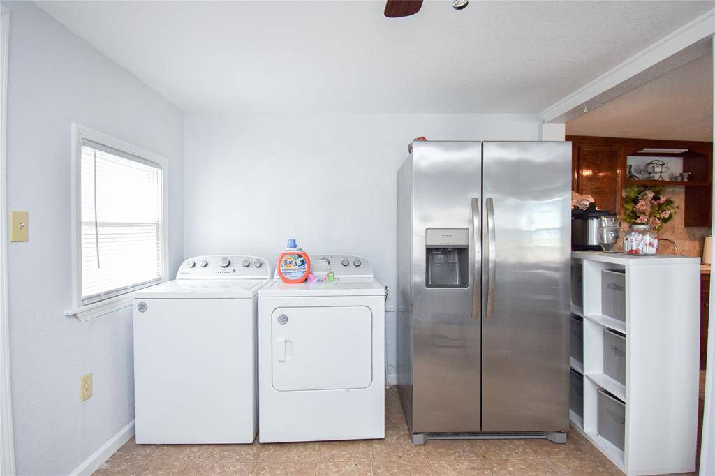 Convenient utility room just off the kitchen, fully equipped with a washer and dryer- making laundry day a breeze.