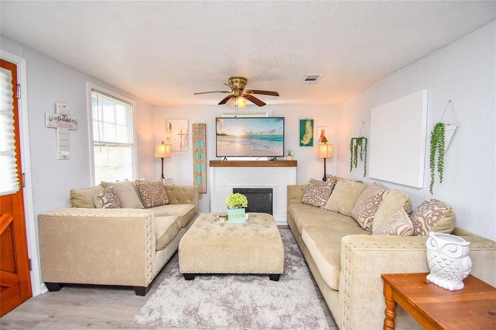 Enjoy the fresh, modern feel with updated flooring and freshly painted walls in this spacious living area.
