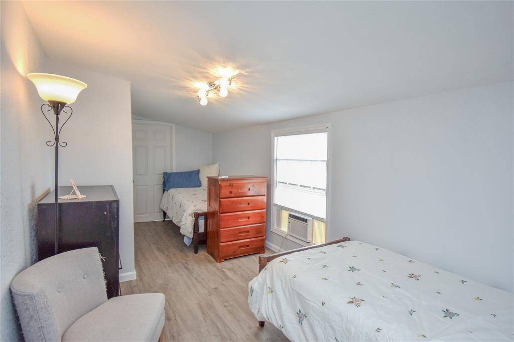 Private and practical- this bedroom features its own ensuite bathroom and a dedicated window unit for personalized comfort.