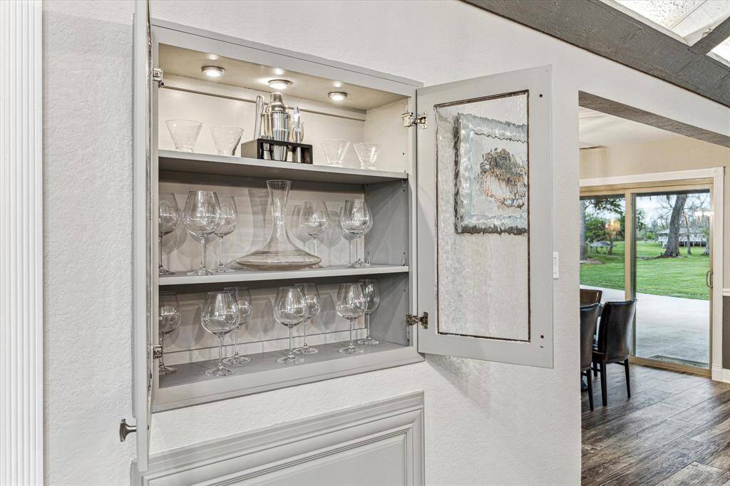 Custom built-ins add a touch of sophistication to this already amazing home. This dry bar with glass doors is a beautiful feature providing the perfect space to display your stemware and other collectibles.