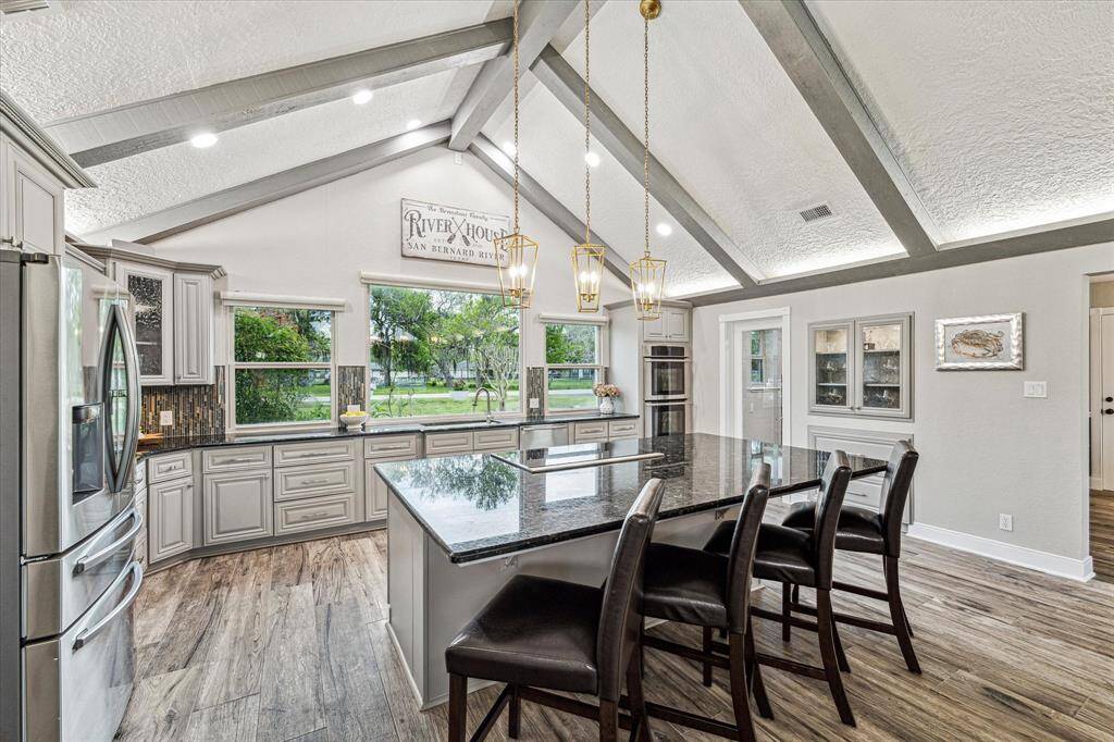 This immaculate updated kitchen is ready for you to show off your culinary skills. Find gorgeous granite countertops, designer tile backsplash, freshly painted cabinetry, sleek stainless steel appliances, a huge walk-in pantry, an oversized island with chic lighting above, and so much more.