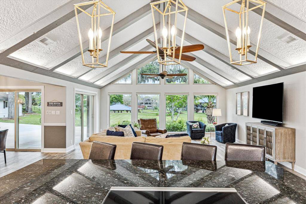 This amazing open floor plan allows you to easily mingle with guests. An oversized bar, with exquisite lighting above, separates the kitchen from the family room. This is a great feature for serving drinks and snacks or add barstools to create additional seating. Also note the Wolf brand induction cooktop.