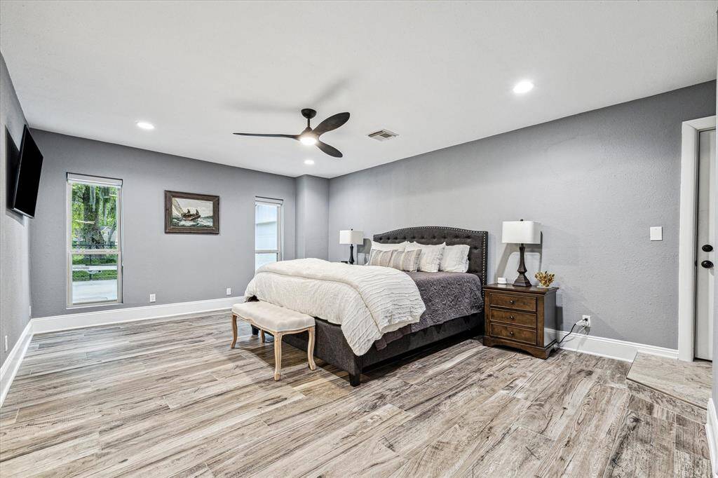 You will rest comfortably in this spacious primary suite. Find gorgeous flooring, fresh paint, recessed lights and a modern lit fan, oversized windows, lots of closet space, and a beautifully updated ensuite bathroom.