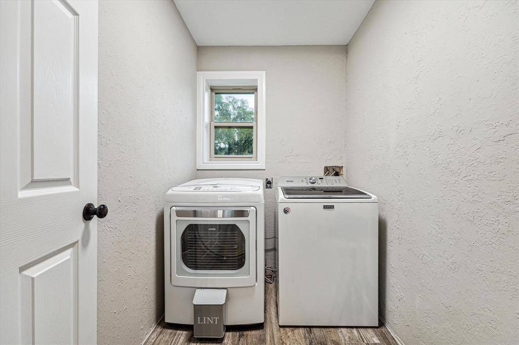 This convenient utility area offers recent flooring and fresh paint.