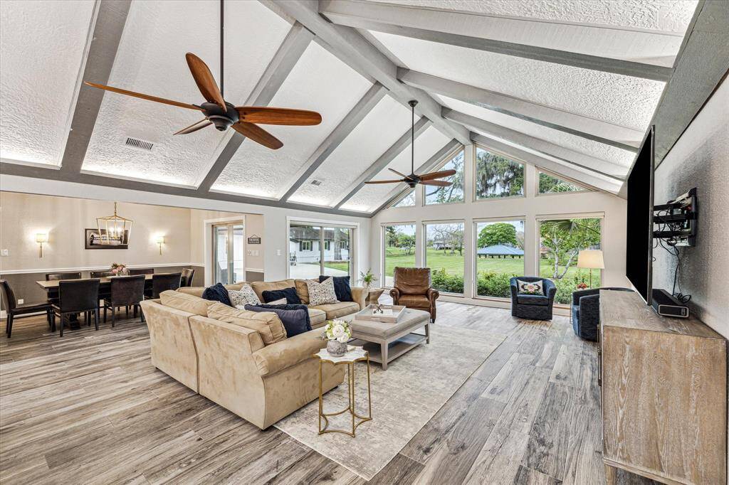 This impressive home offers an open airy floor plan with a cathedral ceiling with uplighting, oversized fans, and dramatic wood beams. Also find beautiful and durable wood-look tile flooring, fresh designer paint, sliding doors leading to covered outdoor areas, an elegant dining area, and massive floor to ceiling windows with stunning views.