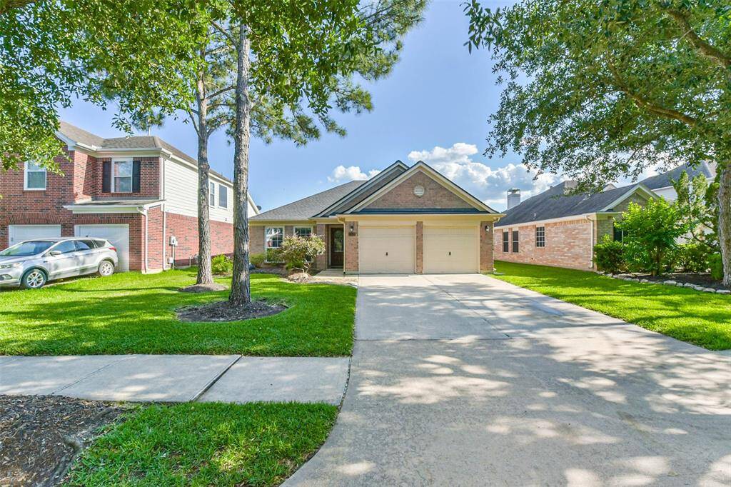 Welcoming curb appeal with a classic brick elevation and mature landscaping.