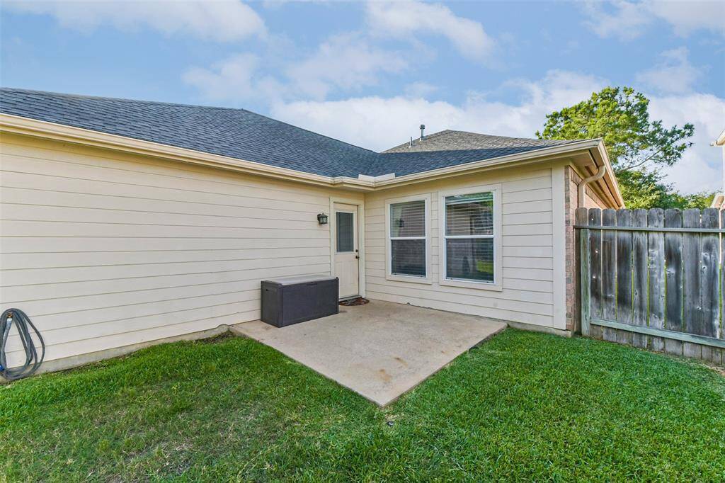 Lush, green yard with plenty of space to play, relax, or garden.