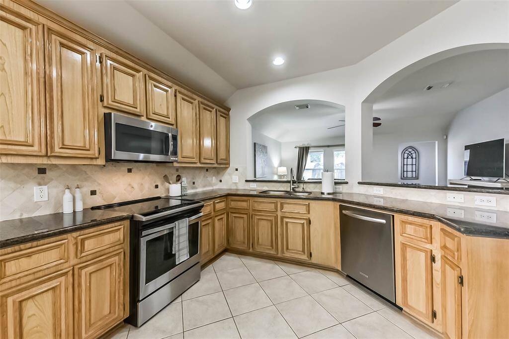 Gorgeous granite countertops and 42” solid wood cabinetry for ample amounts of storage.