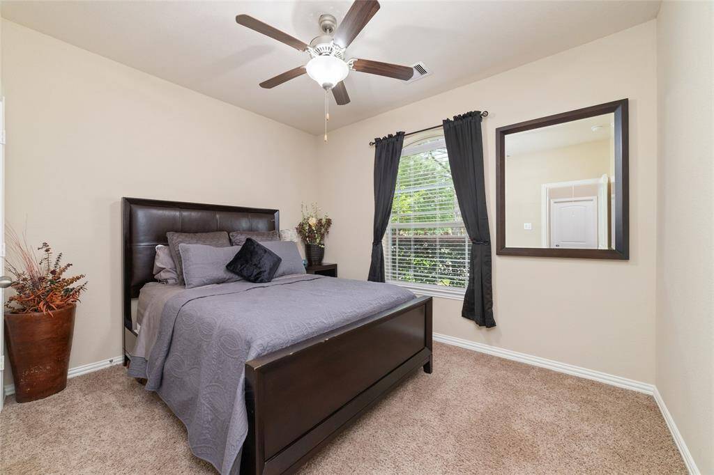 Large secondary room with ceiling fan.