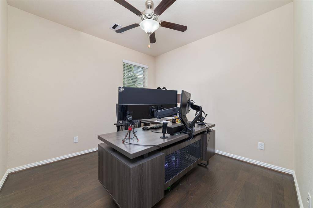 Another bedroom with wood flooring and ceiling fan.