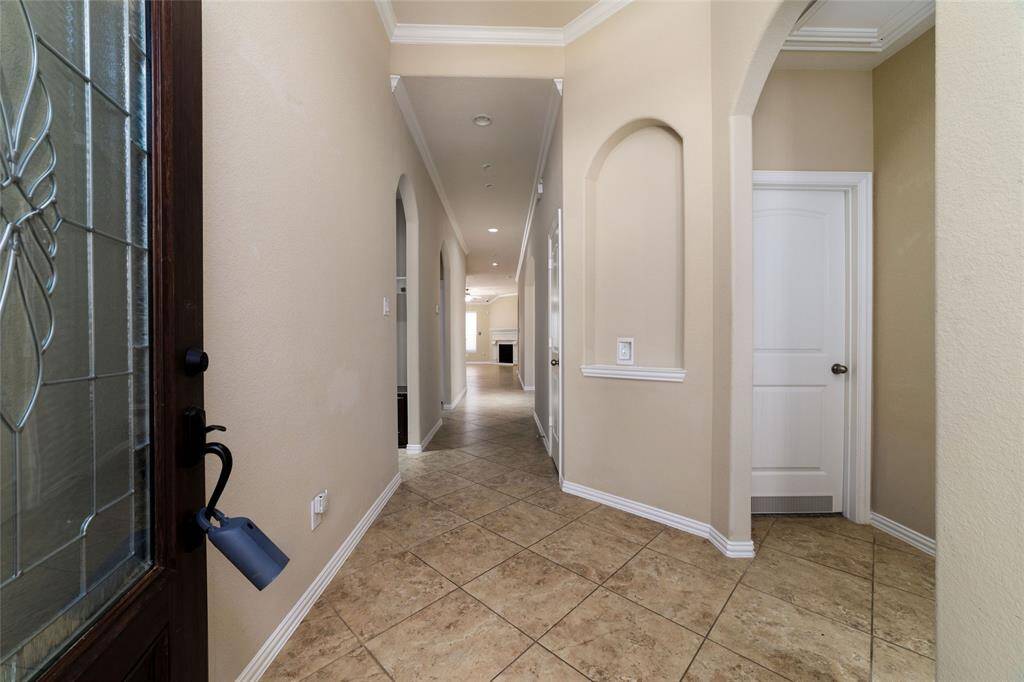 Your entrance with high ceilings crown molding and art niche.