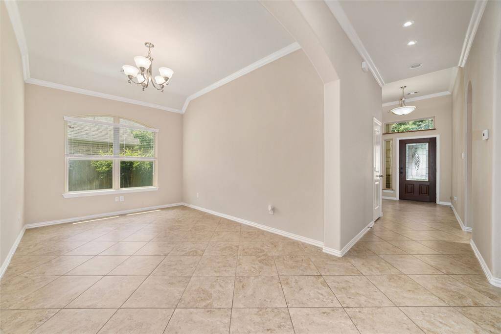 View of your entry way and formal dining room. Lighting added to entryway for art displays.