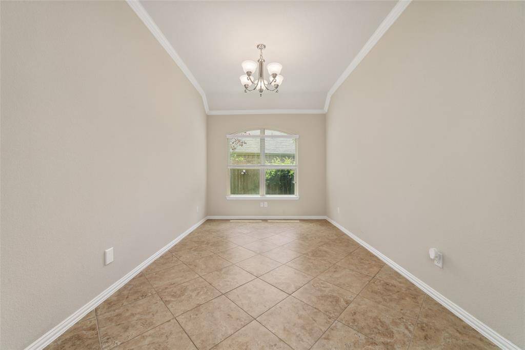 Large formal dining room with crown molding.