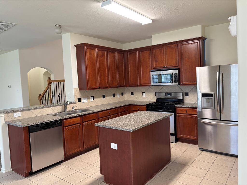 Kitchen with Granite Countertops and a spacious Island.
