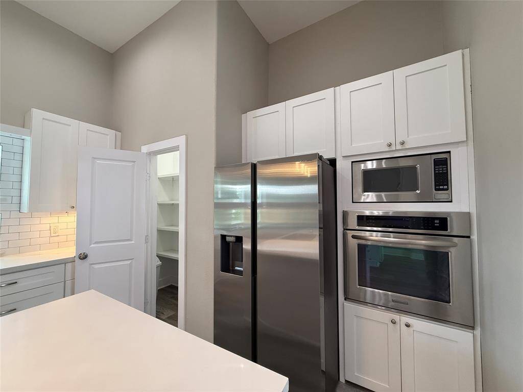 Next to the side-by-side refrigerator, with in-door ice/water service, is a step-in pantry. The oven offers the option of convection baking.
